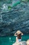 Young girl in a cove on a rock in the Cinque Terre Reserve. Stunning nature and fresh air