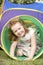 Young Girl Crawling Through Play Equipment