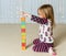 Young girl creating Obamacare tower from wood blocks
