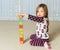 Young girl creating Obamacare tower from wood blocks