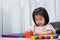 Young girl creative playing colorful toy blocks for homeschooling. Play, learning and imagination concept