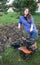 Young girl with a cultivator in the field plowing land