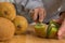 Young girl cutting a kiwi