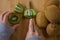 Young girl cutting a kiwi