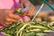 Young girl cutting okra lady finger with knife, preparing bhindi for cook