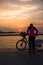 A young girl cyclist during cloudy sunset at Corniche Abu Dhbai, UAE