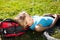 Young girl cyclist enjoying relaxation lying in the fresh grass