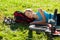 Young girl cyclist enjoying sleeps relax lying in the fresh grass