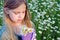 Young girl with daisies in purple sneaker