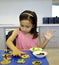 A Young Girl Decorating Biscuits.