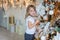 Young girl decorating Christmas tree