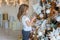 Young girl decorating Christmas tree