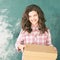 Young girl with delivery box. Happy child relocation stuff. Holding mail gift