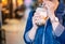 Young girl in denim jacket is drinking brown sugar flavored tapioca pearl bubble milk tea with glass straw in night market of