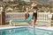 Young girl dipping her toes in the pool