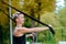 Young girl doing exercises outdoors, holds TRX loop/