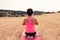 Young girl doing yoga in the middle of a wheat field. Meditation and relaxation concept