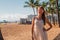 Young girl in a dress walking down the Honolulu Waikiki beach