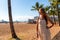 Young girl in a dress walking down the Honolulu Waikiki beach