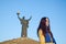 Young girl dressed in Ukrainian national colors against blue sky