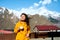 A young girl is drinking morning coffee overlooking Mount Kazbek and basking in the sun. Travel in Georgia