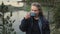 A young girl is drinking tea in nature. A tourist is drinking coffee near the lake.