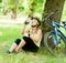 Young girl drinks water from a bottle after mountain biking