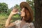 A young girl drinks water from a bottle in nature. Pure drinking water in a plastic bottle.