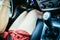 Young girl drives a car with manual transmission, shift lever