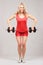 Young girl with dumbbells on the light background