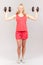 Young girl with dumbbells on the light background
