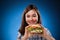 Young girl eating big sandwich