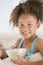 Young girl eating cereal in living room