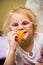 Young girl eating chips making funny face