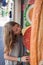 A young girl eating giant fake sandwich