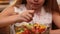 Young girl eating mixed vegetables salad - enjoying every bite