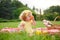 Young girl eating orange sitting on blanket