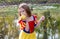 Young girl eats an apple in her princess Halloween costume