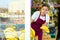 Young girl employees in uniform lay out and selling banana in grocery shop