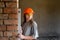 A young girl engineer holds a level measuring the evenness of the walls.