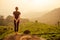 Young girl enjoying a good morning in tea plantations in India Munnar Kerala