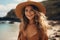 Young girl enjoying a leisurely stroll on the sandy beach, adorned with a stylish sun hat