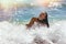 Young girl enjoying the sea waves, carefree vacation