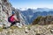 Young girl enjoying the views from a peak in Julian Alps, Triglav National Park, Slovenia, during a break on a via ferrata route