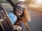 Young Girl Enjoys Feeling Wind Leaning Out of Car Window