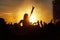 Young girl enjoys a rock concert, Silhouette on sunset