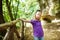 Young girl exploring old caves dug into the tuff rock and used for human habitation in ancient times. Citta del Tufo