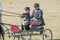 Young girl and father on a horse-drawn cart