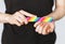 A young girl files her nails with a colored nail file close-up. Nail care. Filing nails on the hands. Women`s nails and nail file.