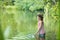 Young girl fishing in Lake using butterfly fishing net